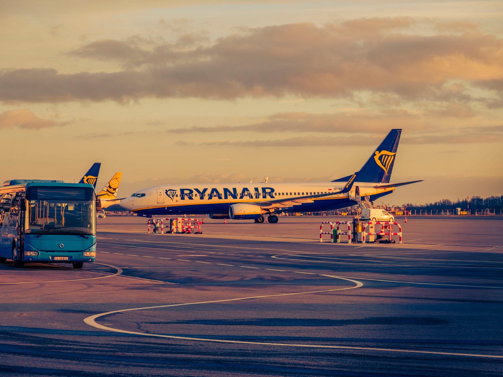 Samolot Ryanair i autobus lotniskowy o zachodzie słońca we Wrocławiu
