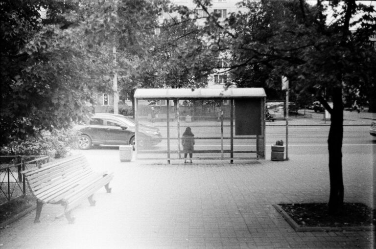 Samotna osoba czekająca na autobus na miejskim przystanku